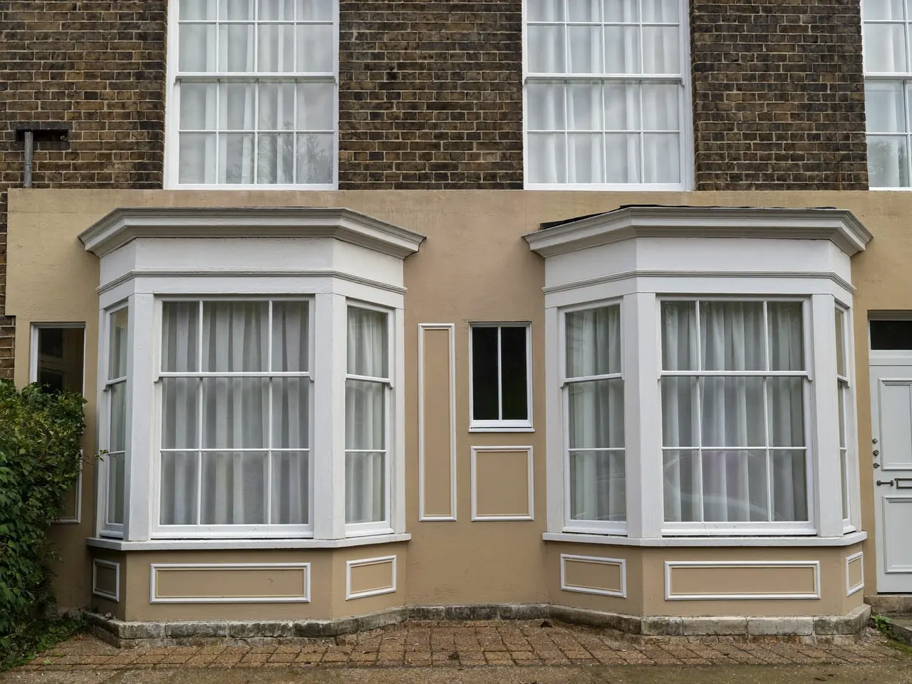 Timber sash windows on a period British townhouse frontage